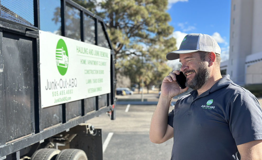 Junk Out ABQ experts on a phone booking a service